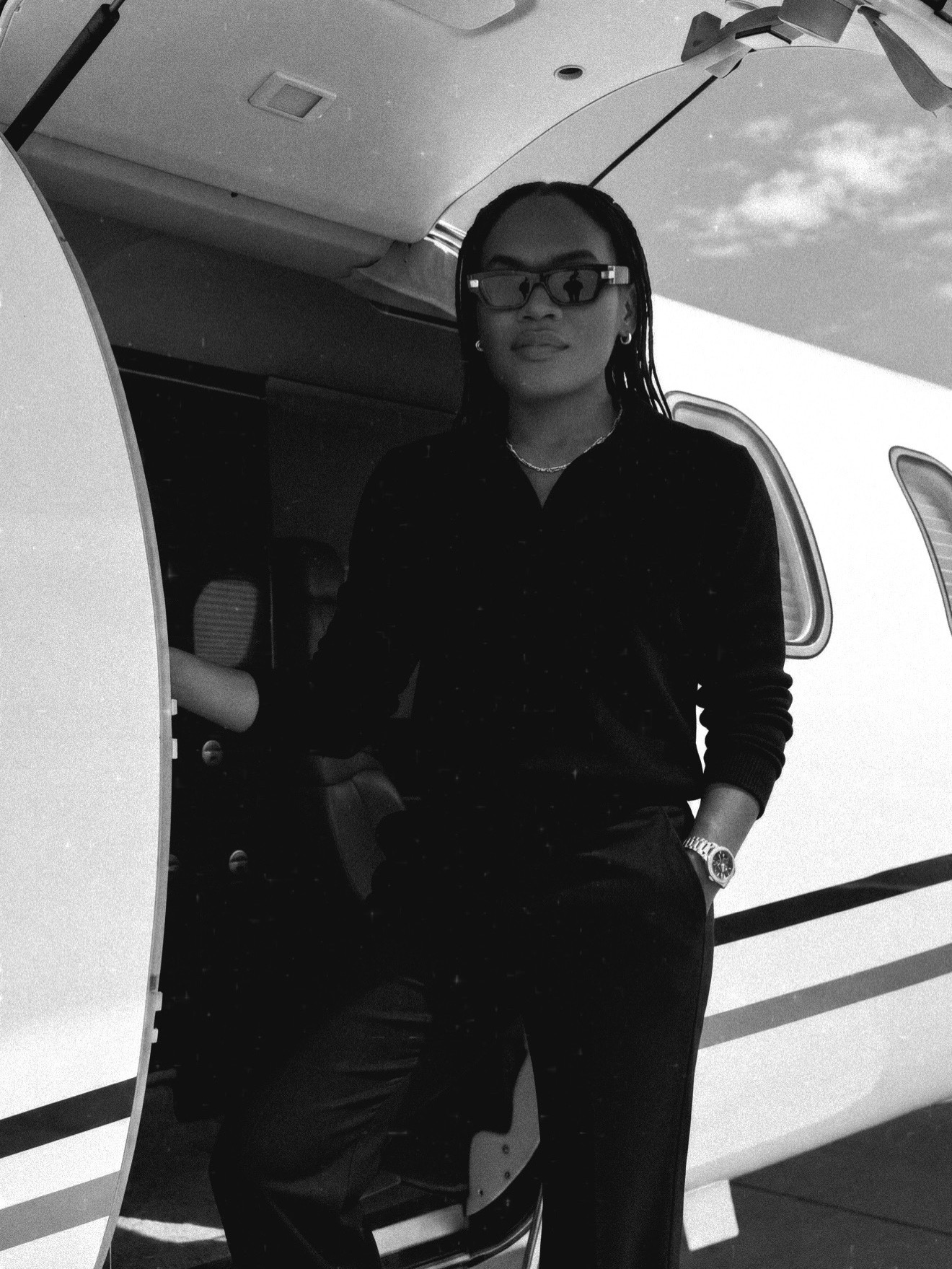 Kris Buban beside a private jet