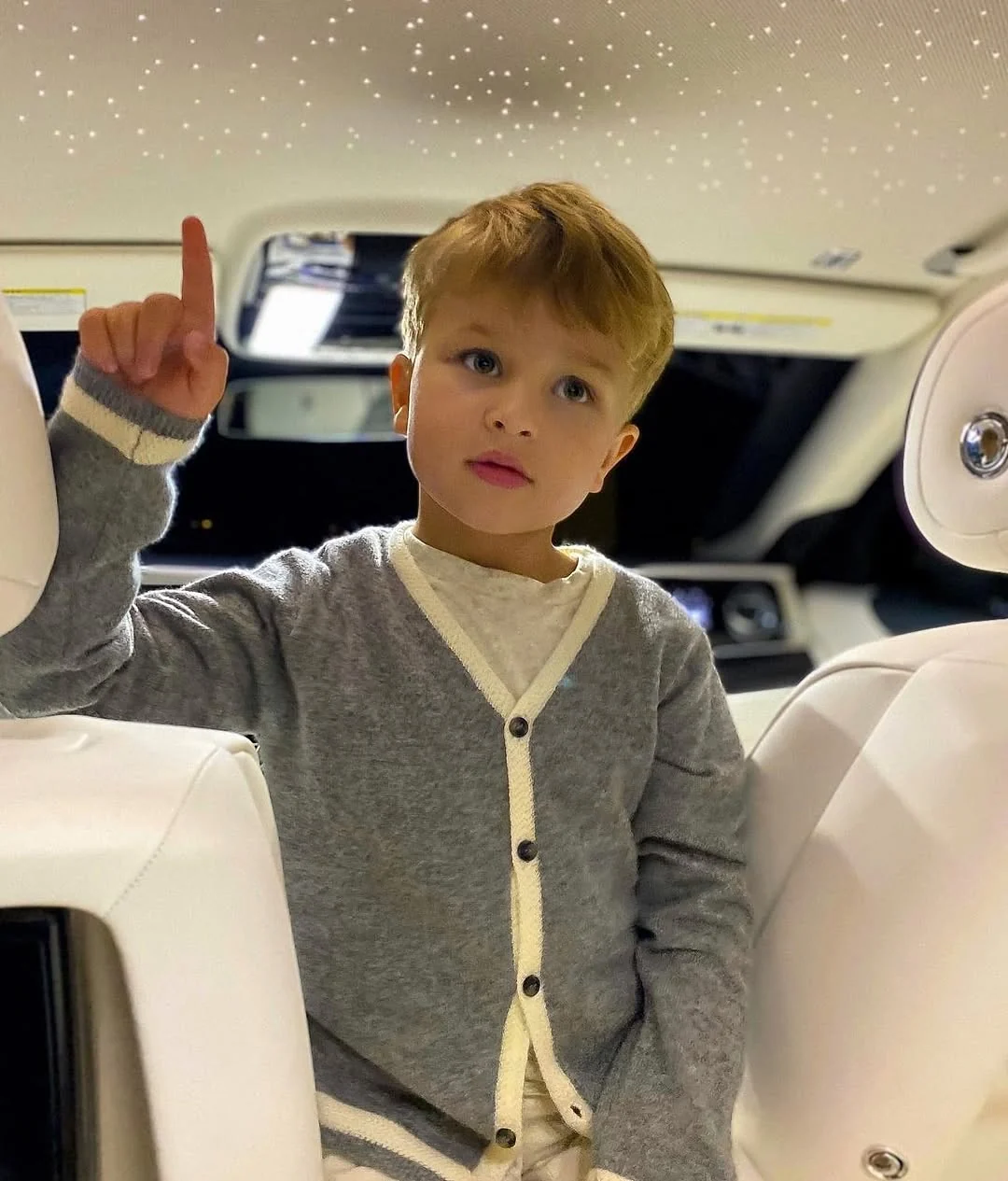 A child seated in a luxury vehicle